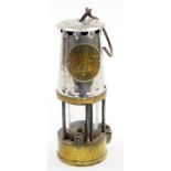 A Protector Lamp Lighting Co Ltd miner's lamp, stamped number 22, in steel and brass, 23cm high.