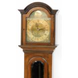 A grandmother clock, the arched brass dial signed Tempus Fugit, silvered chapter ring bearing