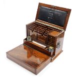 A late Victorian walnut and burr walnut stationary cabinet, stamped to the interior leather