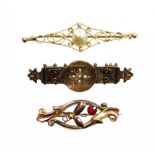 Three early 20thC yellow metal bar brooches, one set with a garnet, another with seed pearls, and