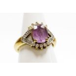 A silver amethyst and cubic zirconia set dress ring, the V splayed shoulders set with cz stones,