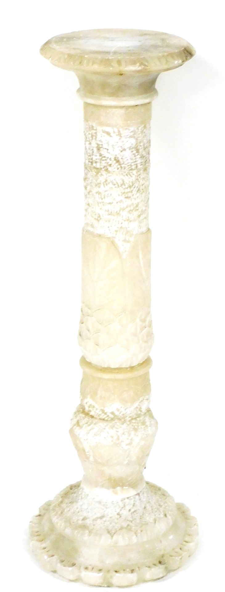 A carved alabaster torchere, decorated with leaves, petals, etc., 90cm high.