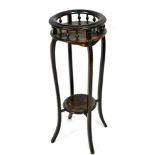 An ebonised beech plant stand, the circular moulded raised gallery, on spindle turned supports
