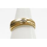 A 9ct gold dress ring, with three row banded design and set with tiny diamond, in tension setting,