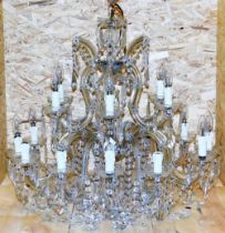 A cut glass chandelier, with rows of beads and faceted lustre drops, formed as two tiers of six