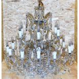 A cut glass chandelier, with rows of beads and faceted lustre drops, formed as two tiers of six