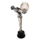 A metal finish resin Art Deco style table lamp, modelled in the form of a nude lady holding the