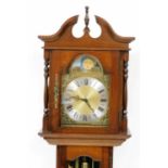 An Emperor Clock Company grandmother clock, the arched brass dial with moon phase, silvered