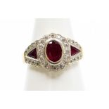 Withdrawn presale by vendor- An 18ct gold ruby and diamond Art Deco style dress ring, the central