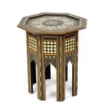 An early 20thC Anglo Indian hardwood occasional table, the octagonal top inlaid in mother of pearl