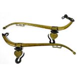 A pair of patent lion double cased solid brass horse hames, number 2, with cast iron hook and