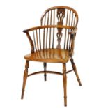 A 19thC yew and elm Windsor chair, with a pierced splat, spindle turned supports and a solid seat,