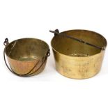 Two graduated brass jam pans, with cast iron handles.