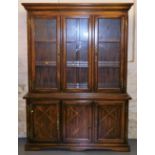 A hardwood display cabinet, the top with two glazed doors, the base with three panelled doors, 193cm