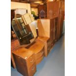 A mid 20thC oak bedroom suite, comprising single wardrobe, compactum, and a glazed back dressing