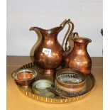 A set of four miniature copper and brass saucepans, a copper flagon, 36cm high, brass tray, 37cm