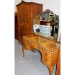 A mid 20thC burr walnut kidney shaped dressing table, with a triple mirrored back, approx 158cm