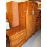 A mid 20thC three piece bedroom suite, comprising double wardrobe, a chest of three drawers, and a