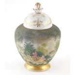 A 20thC Sitzendorf vase, with gilt highlighted domed lid and shouldered circular body, decorated wit