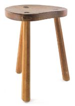 A Peter Heap of Wetwang Rabbitman oak cow stool, with saddle seat carved with rabbit on three legs,