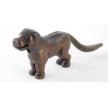 A 20thC standing bronze effect cast iron dog nutcracker, with articulated mouth and tail.