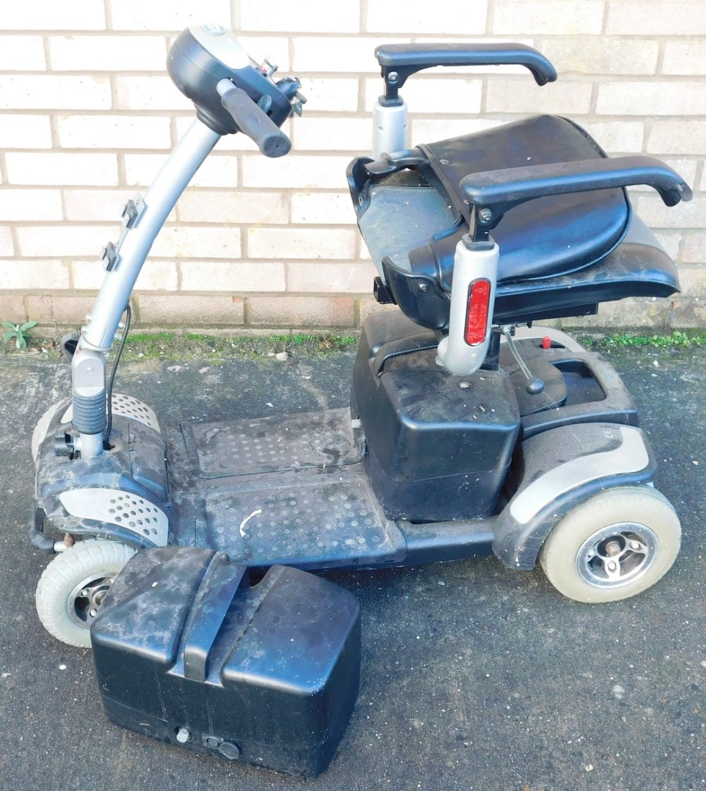 A TGA four wheel mobility scooter, with key and charger, 89cm high.