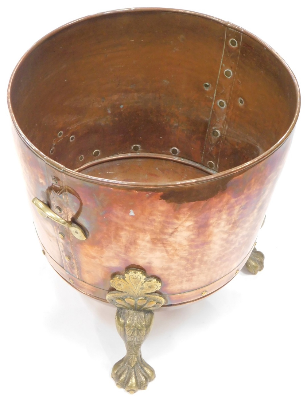 A late 19thC hammered copper coal bucket, with brass mount on hairy paw feet, 39cm high, 42cm wide.