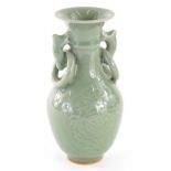 A Chinese celadon vase, of small proportions, with fixed ring handles and shouldered body, decorated