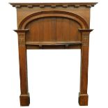 An early 20thC oak Arts and Crafts style fire surround, with moulded bow shaped mantel, a slatted re