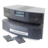 A Bose Wave III music system, no. 055426330980245AE and an AWR1-2W Bose Wave radio, each with wires