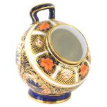 A Royal Crown Derby Imari pattern open salt pot, of cylindrical form with upper handle on circular f