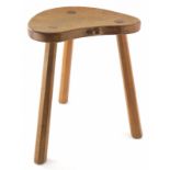 A 1970s Robert Thompson of Kilburn Mouseman oak cow stool, with saddle seat carved with mouse to the