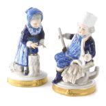 A pair of Unker Weiss Bach figures of children, each decorated in finery on gilt highlighted bases,