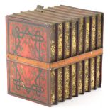 An early 20thC Huntley and Palmers biscuit tin, in the form of books in red, 16cm high.