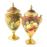 A pair of Coalport vases, by Higham and Goodwin, hand painted with fruit and gilt highlights, compre