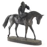 A resin bronze finish figure group of horse and jockey, indistinct label beneath, 18cm high.