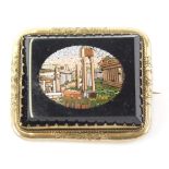 A 19thC Italian micro mosaic brooch, decorated with ruins on a rectangular black onyx backing, in a