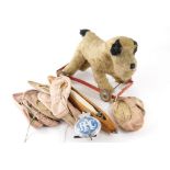 A 1950s plush jointed dog on wheels toy, 26cm high, possibly Mamod and various ballet slippers.