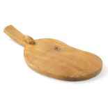 A Peter Heap of Wetwang Rabbitman oak cheese board, with carved rabbit, shaped body and plain handle