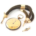 A twist watch chain, set with 9ct gold and other charms, 34cm long, a fancy watch key and early 20th