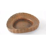 A studio copper sculpted dish, of shaped circular form with studded outline, partially marked, 25cm