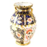 A Royal Crown Derby Imari pattern vase, of oval form with gilt highlights and circular foot, printed