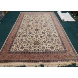 A large Indian carpet in the Persian style, with a design of scrolls, leaves and flowers, on a cream