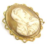 A large religious cameo, of oval form, formed as a lady in flowing robes, quarter profile, in a fanc