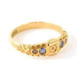 An 18ct gold dress ring, set with blue stones, size O-P. (AF)
