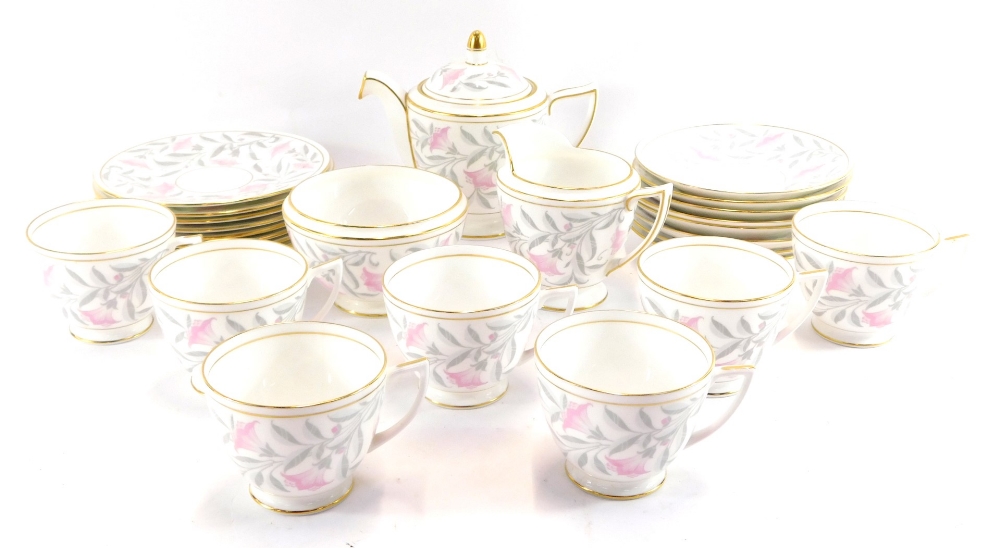 A Minton porcelain tea service in the Petunia pattern, comprising teapot, milk jug, sugar bowl, eigh