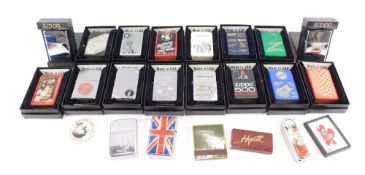 A collection of Zippo lighters, mainly boxed, each with applied decoration. (1 tray)