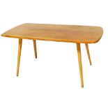 An Ercol light elm dining table, with a rectangular top on tapering supports, the top 149cm x 74cm.