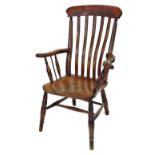 A Victorian beech and elm lath back kitchen chair, with solid saddle seat, stamped to the back with