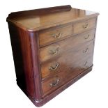 An Edwardian plum pudding mahogany chest, of two short over three long graduated drawers, raised on